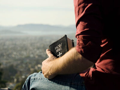 man thinking on a cliff with the bible man thinking on a cliff with the bible